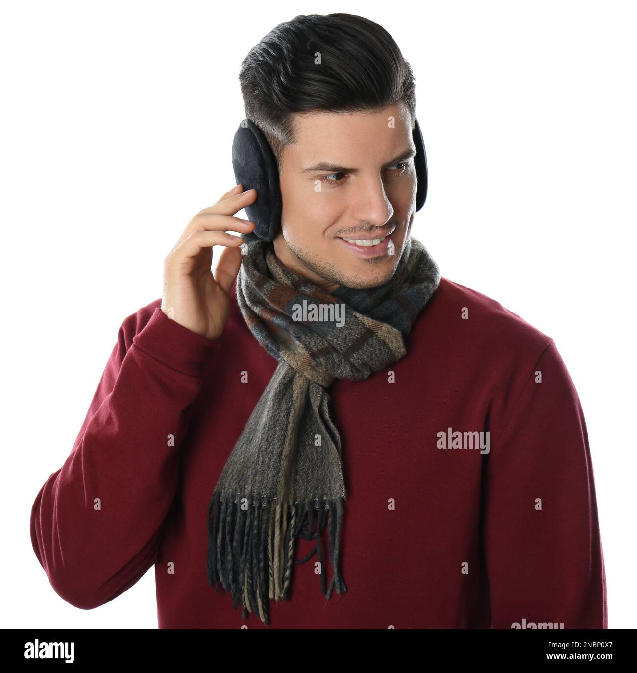 Man wearing stylish earmuffs and scarf on white background Stock Photo