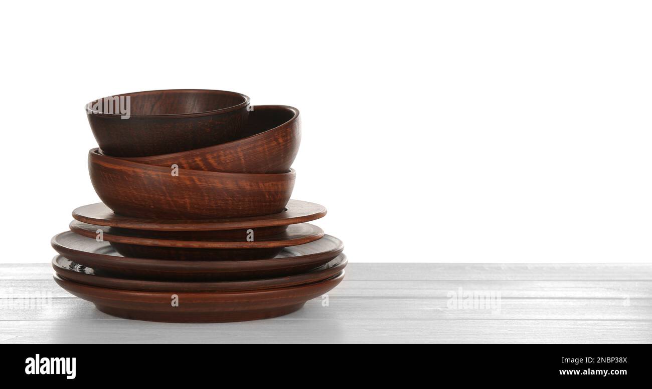 Different clay dishware on white wooden table Stock Photo