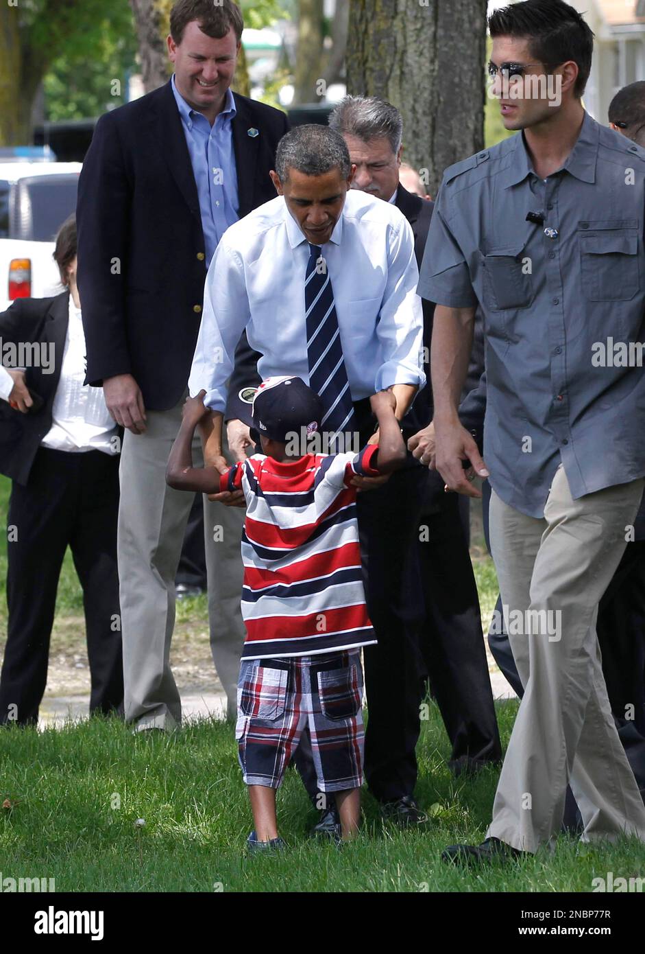 President Barack Obama greets a young boy across the street after