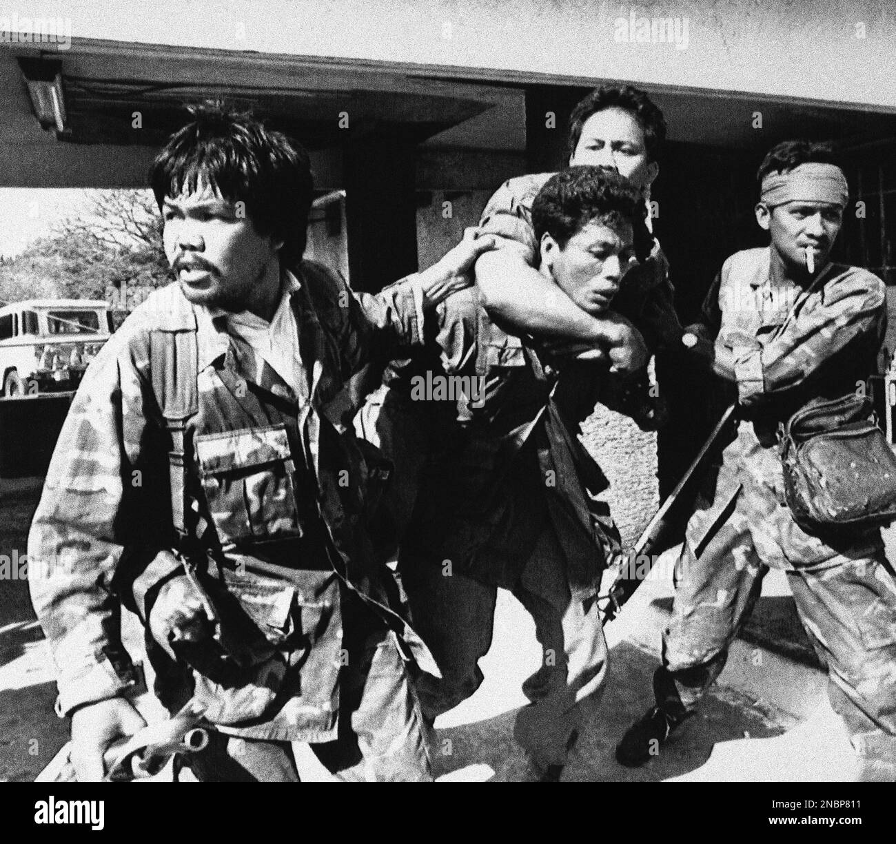 A pro-Marcos soldier is jumped by three rebel soldiers in the takeover ...