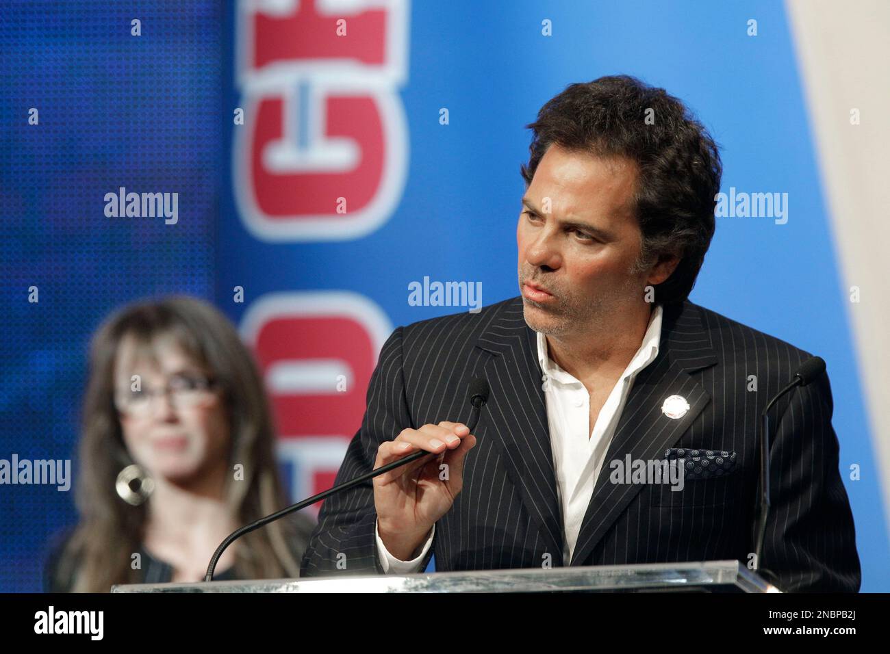Detroit Pistons owner Tom Gores, right, addresses the media at the