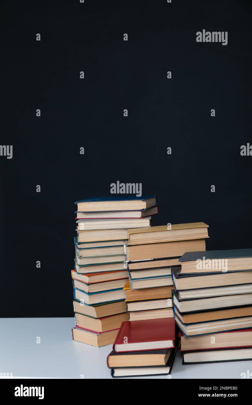 stack of books on dark background in the library at the educational ...