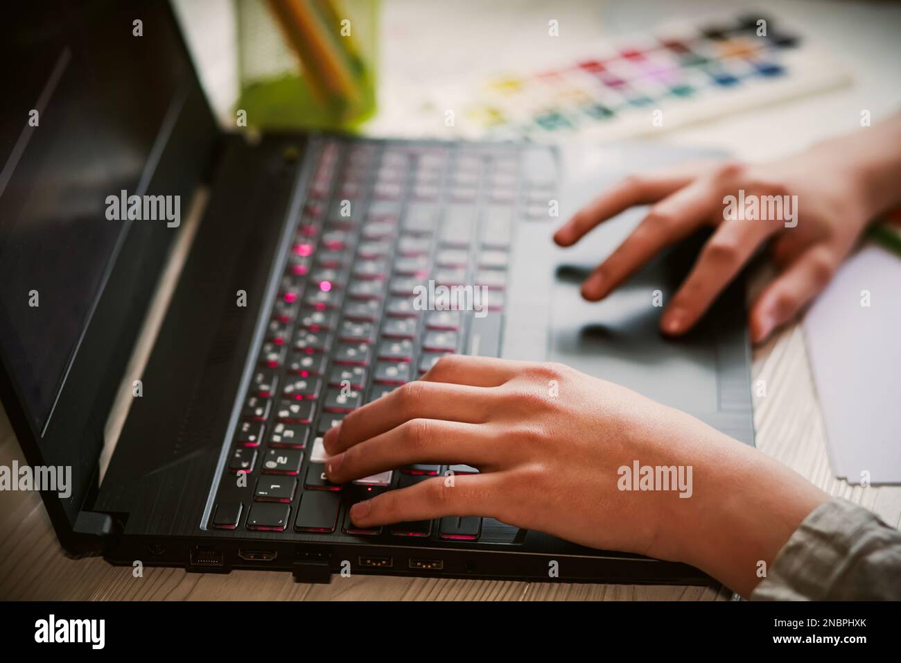 Hands of a teenager working on a laptop computer . home Office concept. back to school Stock Photo