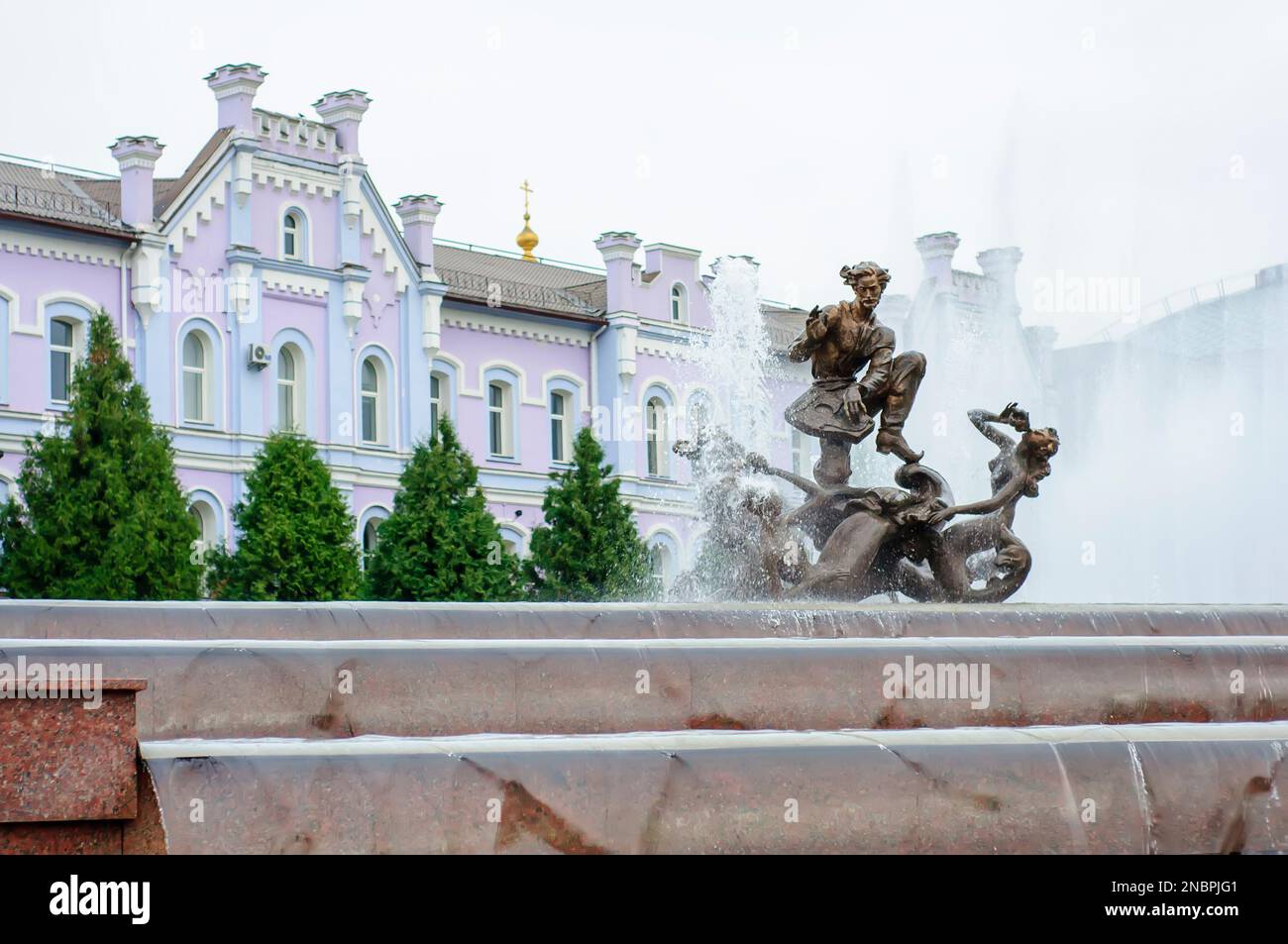 Sumy, Ukraine. August 22. 2014. Sadko Fountain with sculpture and water cascade. Banking Academy in the background. Stock Photo