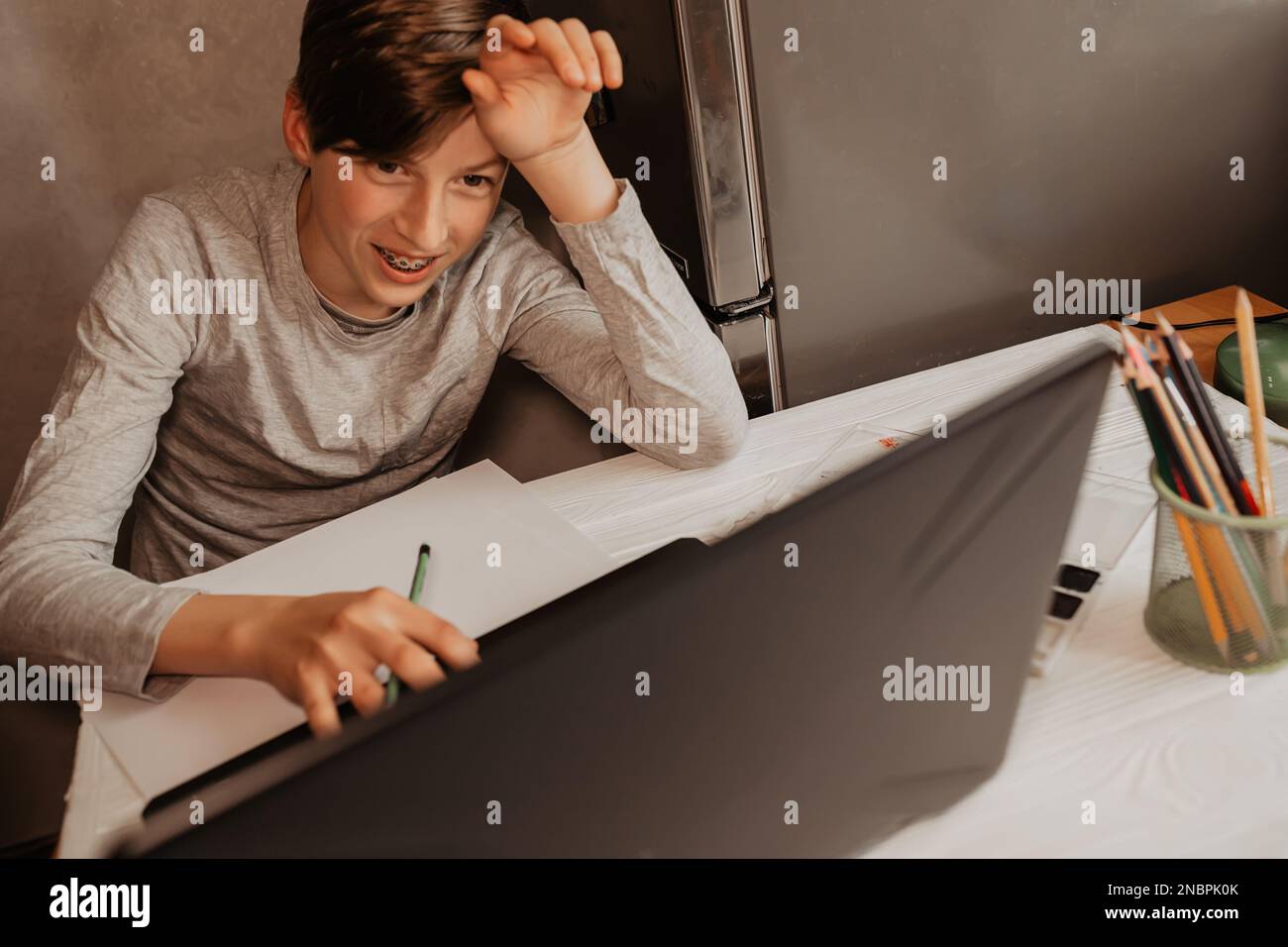 The laptop monitor screen is turned off. The child turns on the laptop ...