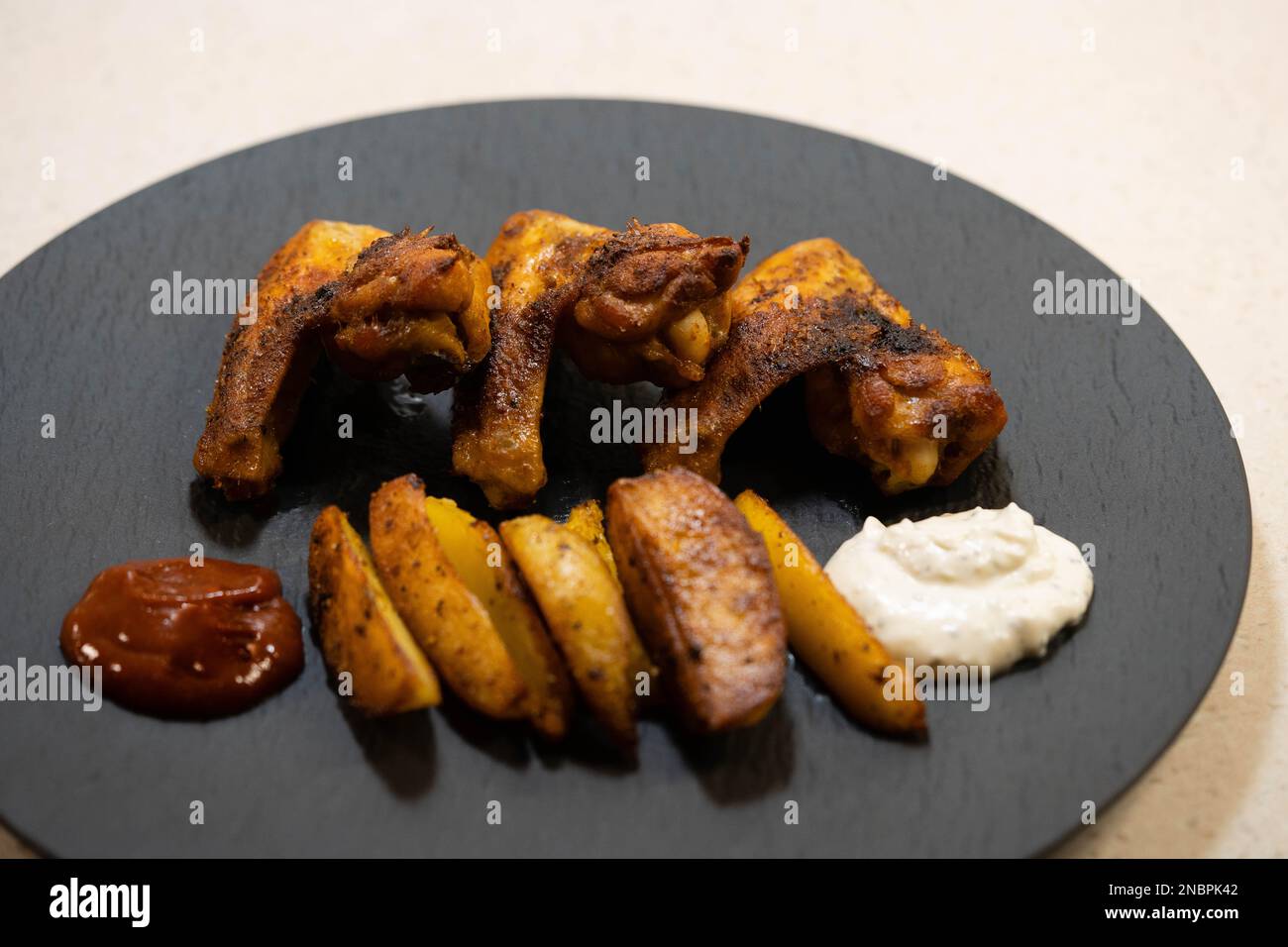 chicken wings with western fries and barbecue sauce Stock Photo - Alamy
