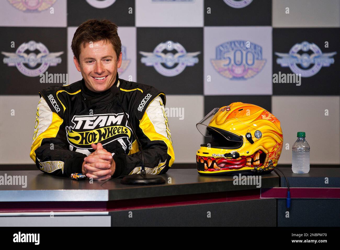 Team Hot Wheels driver Tanner Foust (right) laughs at a question at a press  conference after he set a new world record with a 332 foot distance jump at  the IZOD Presents