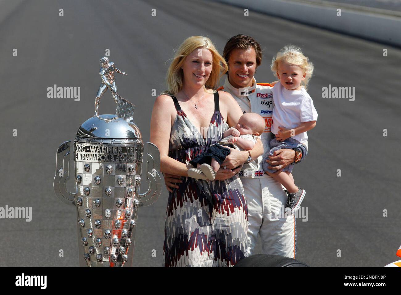 IndyCar driver Dan Wheldon, of England, poses with his family, wife