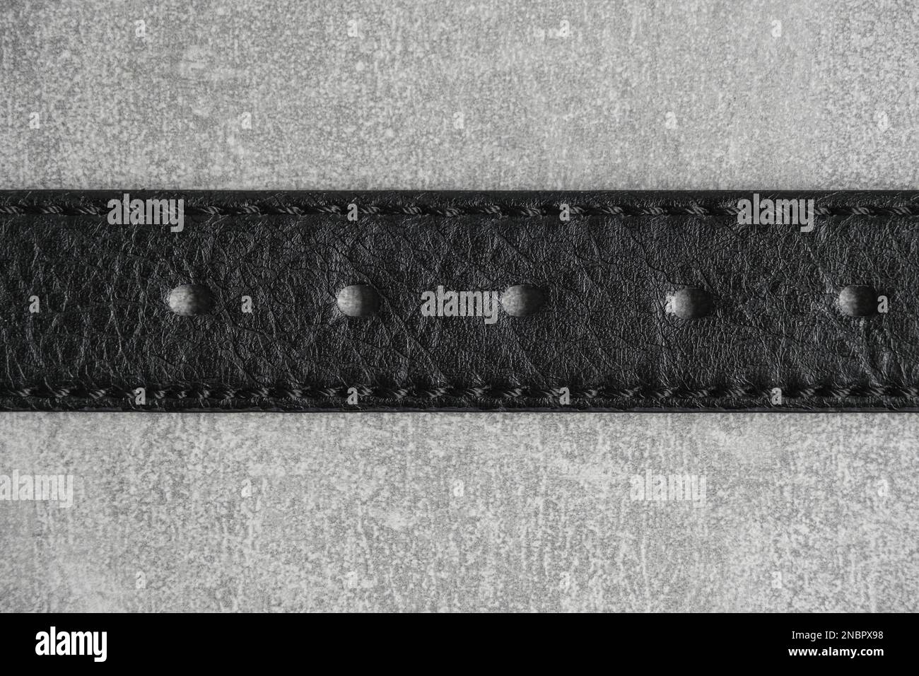 Black leather belt gray concrete background Stock Photo