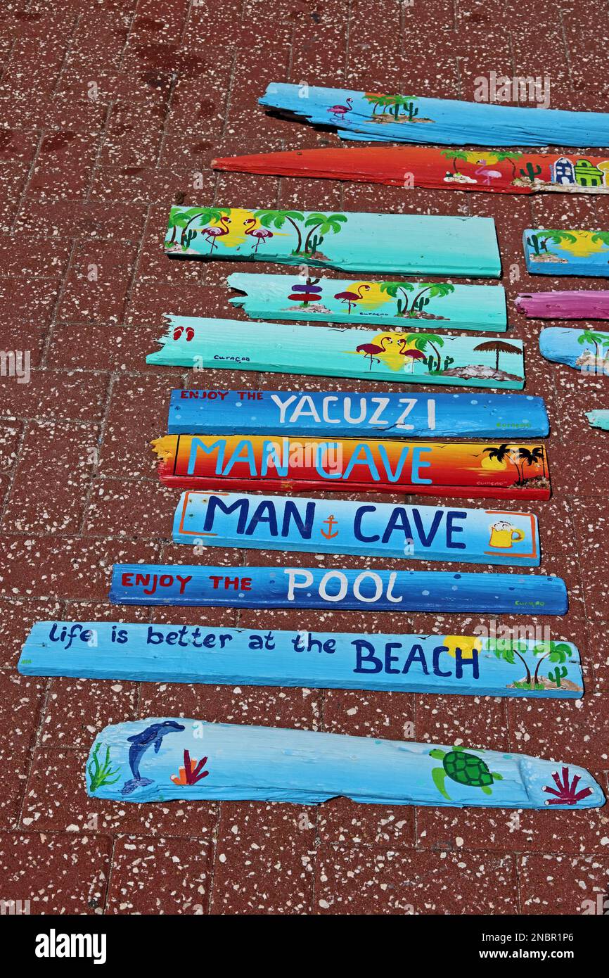 Painted wooden plaques on sale with various messages, Curacao Stock Photo