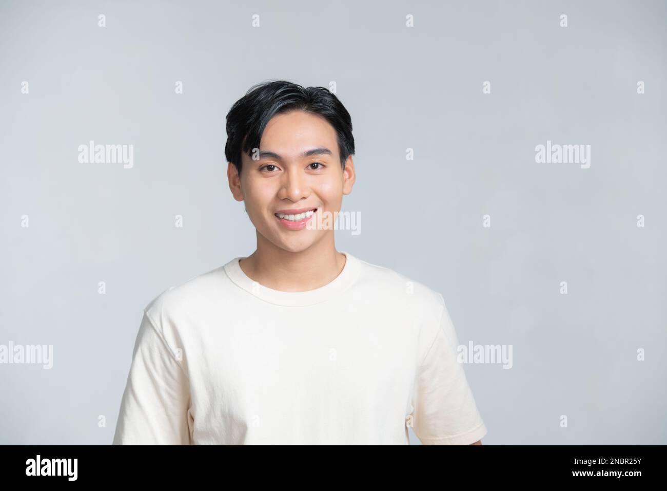 Closeup portrait of asia middle age 20s man wearing white shirt in studio Stock Photo