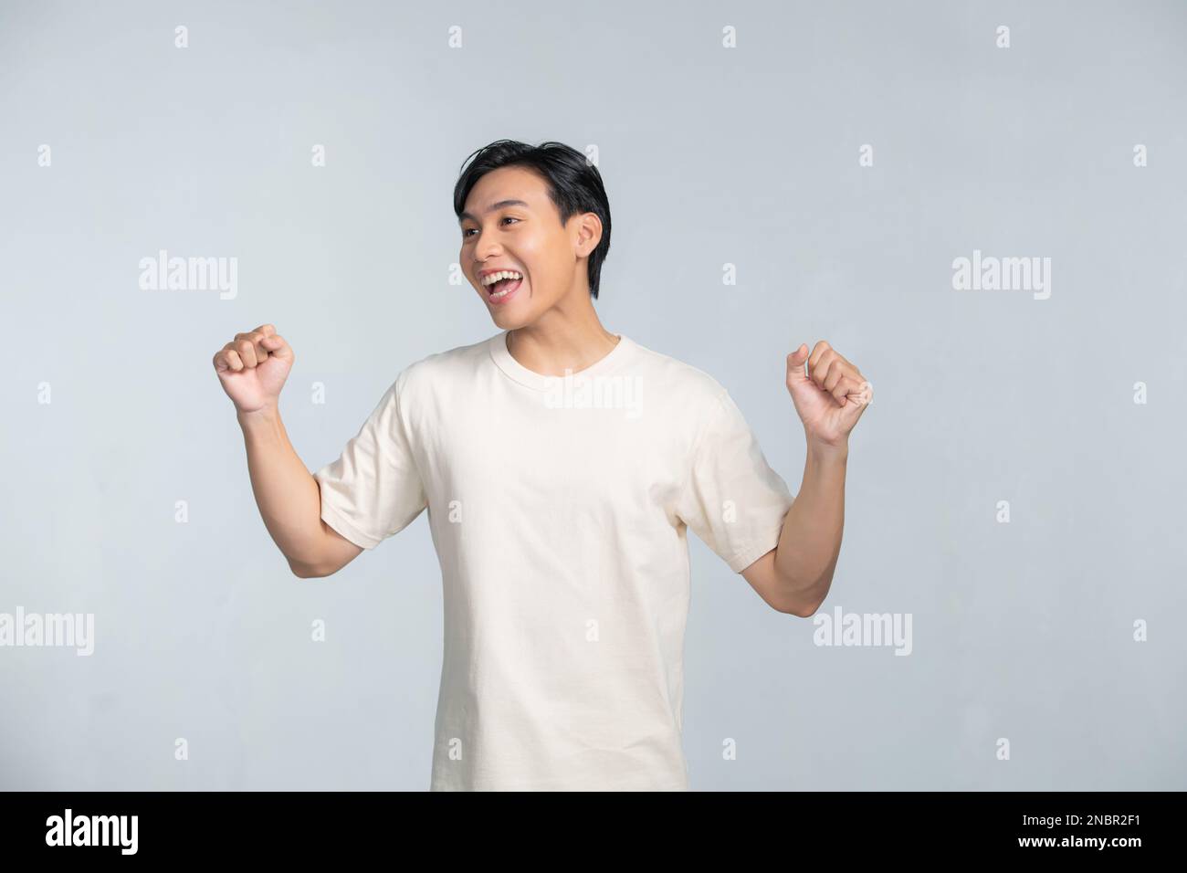 A portrait of happy excited young Asian man isolated on white ...