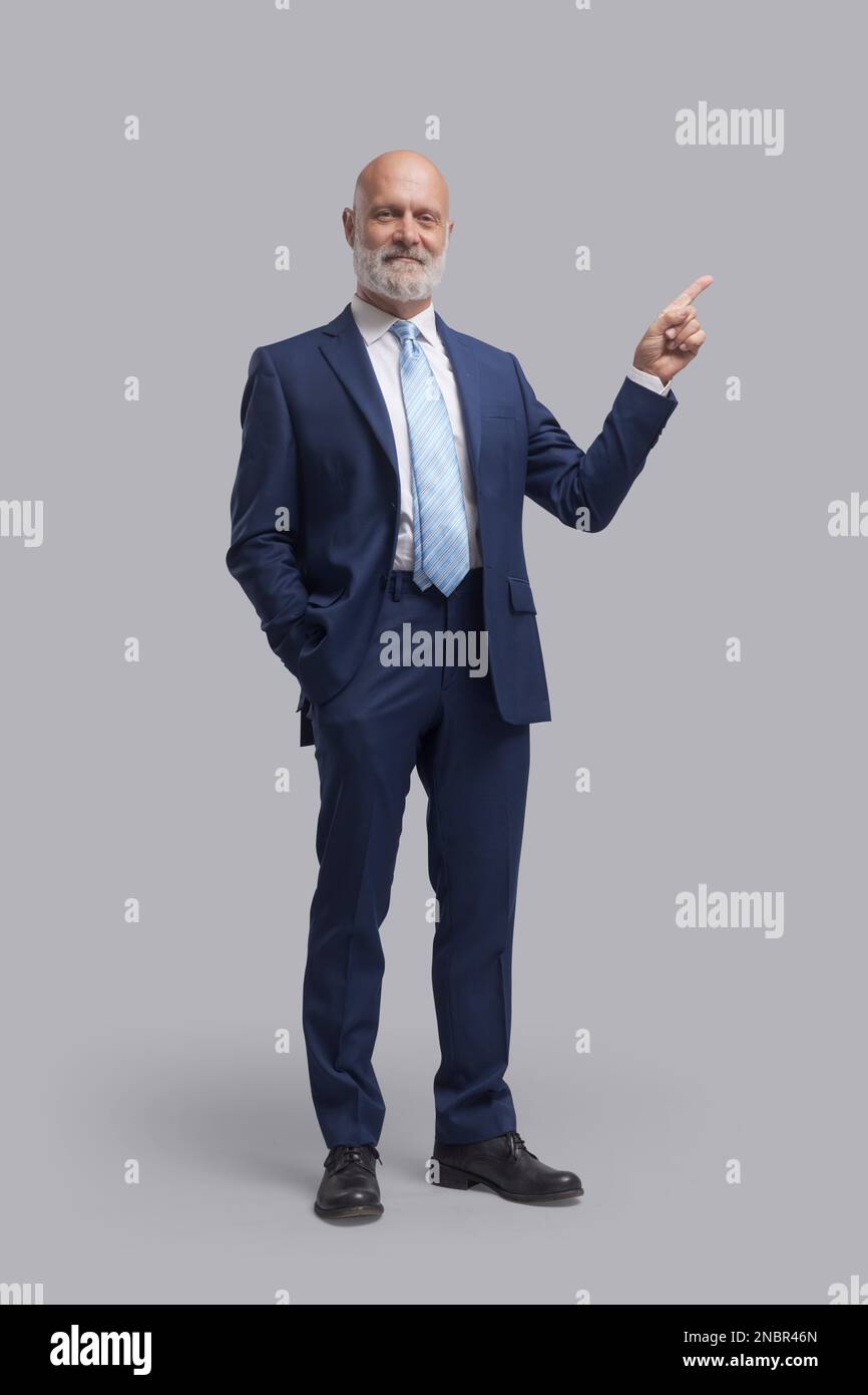 Confident smiling executive pointing and giving business advice Stock ...