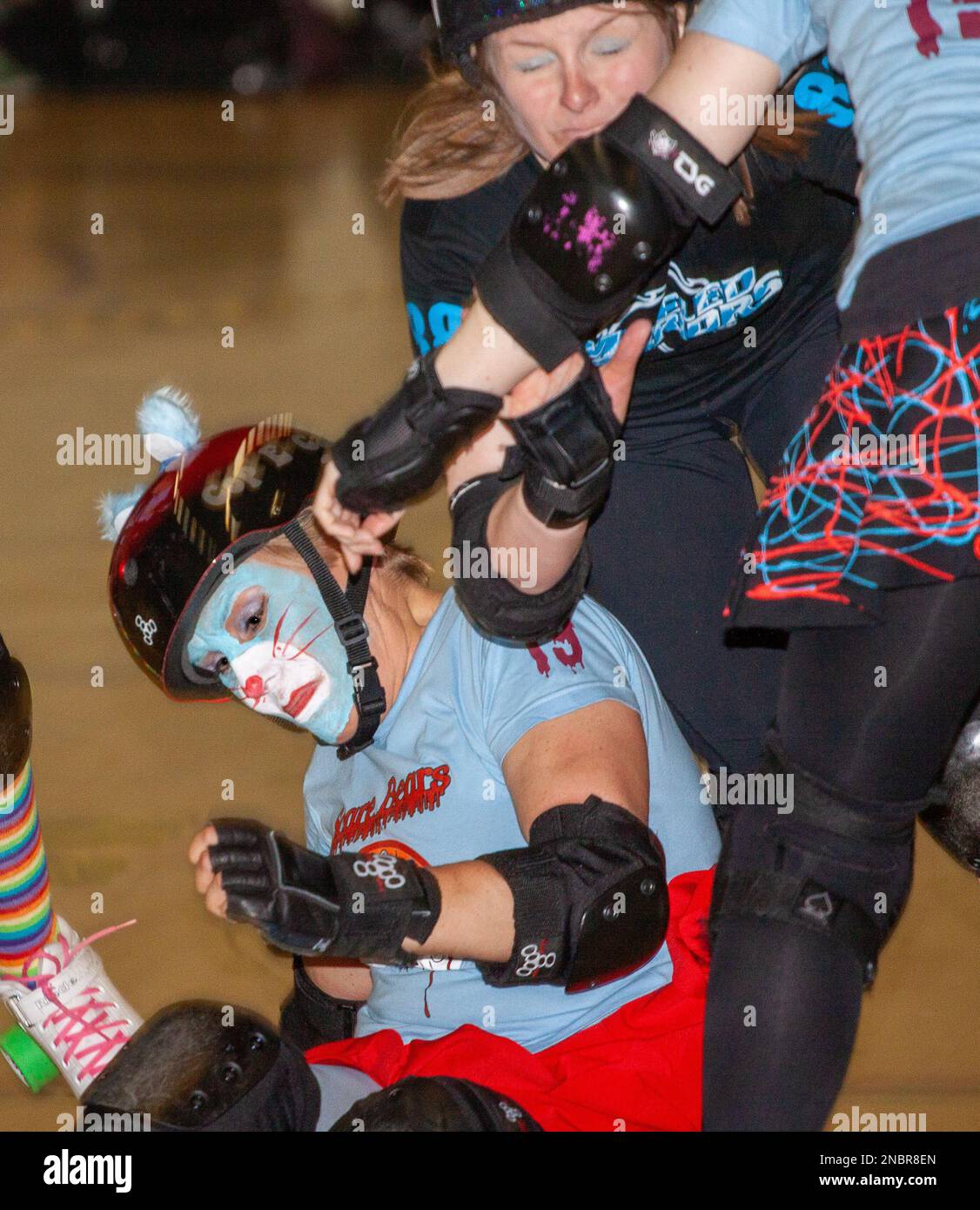 In light blue tops mixed league team Scare Bears competes in a roller derby bout at the Garon Leisure Centre Sounthend Stock Photo