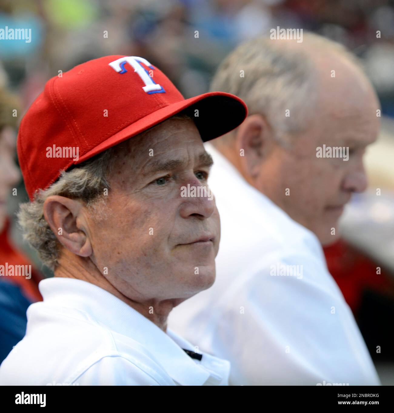 Former President George W. Bush watches a baseball game between the ...