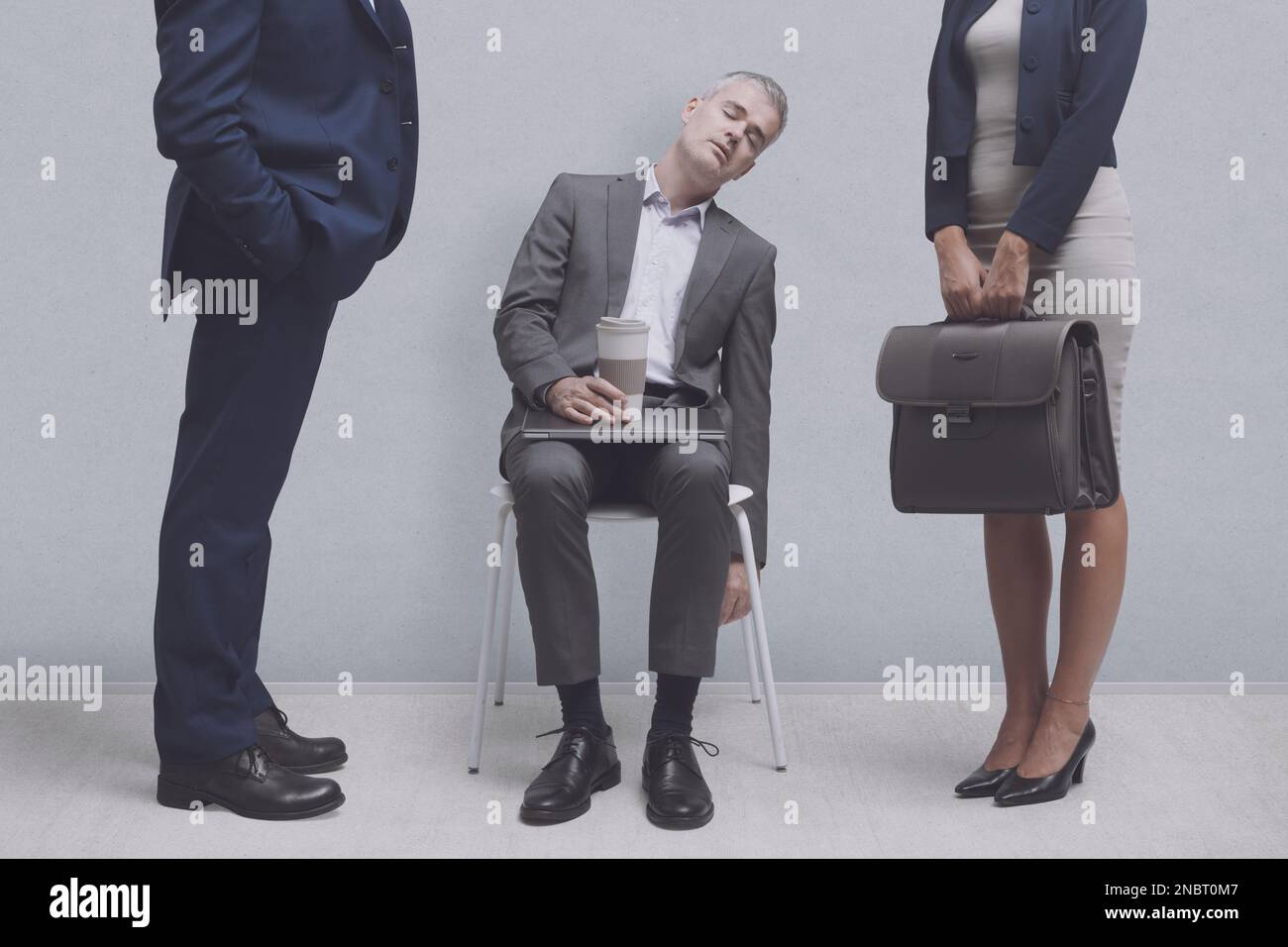 Tired businessman sleeping on a chair in the office, he is lazy and