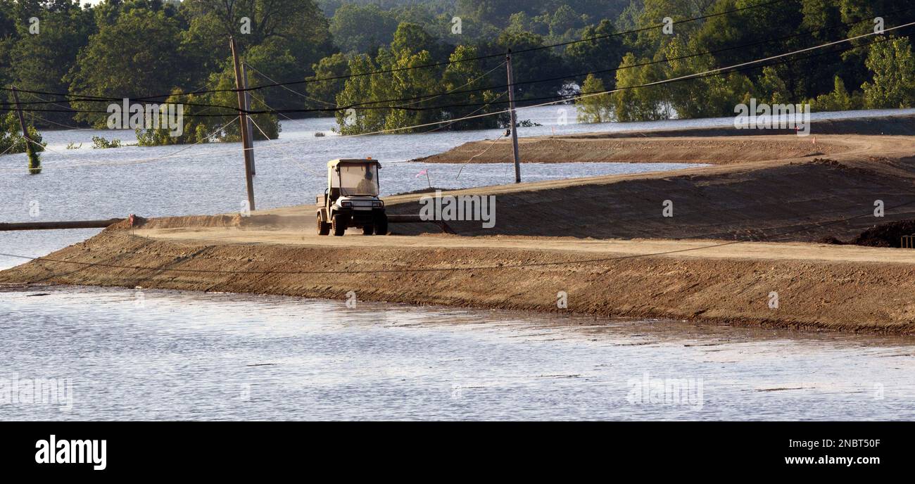 An Anderson Tully Company employee drives around the top of a berm