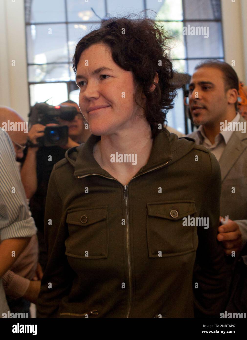 Freed American freelance journalist Clare Morgana Gillis, is followed by  Libyan government spokesman Moussa Ibrahim upon her arival to a hotel where  most of international media stays in Tripoli, Libya, Wednesday, May