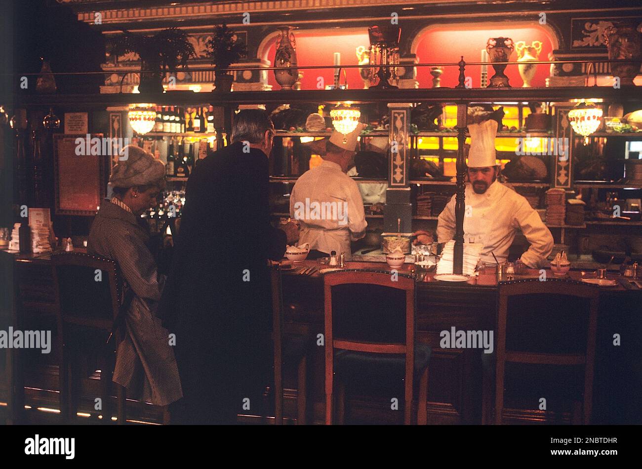 London 1972. A London restaurant interior with two chefs seen behind a counter. Kristoffersson ref DV7 Stock Photo