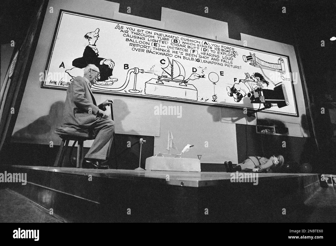 Inventor and cartoonist Rube Goldberg, 87, demonstrates his picture