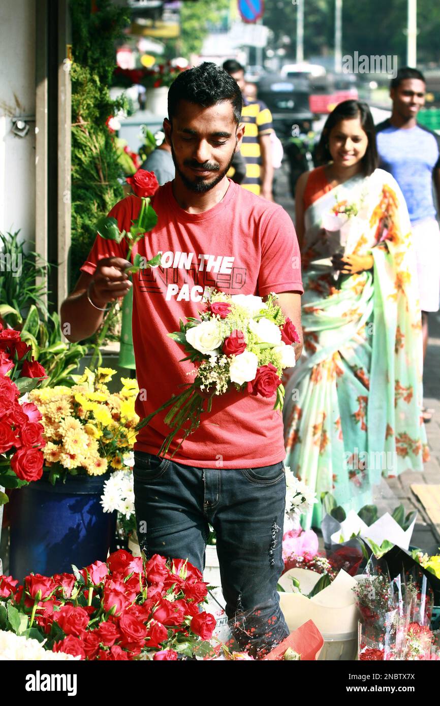 Colombo, Sri Lanka. 14th Feb, 2023. A vendor prepares flowers for sale