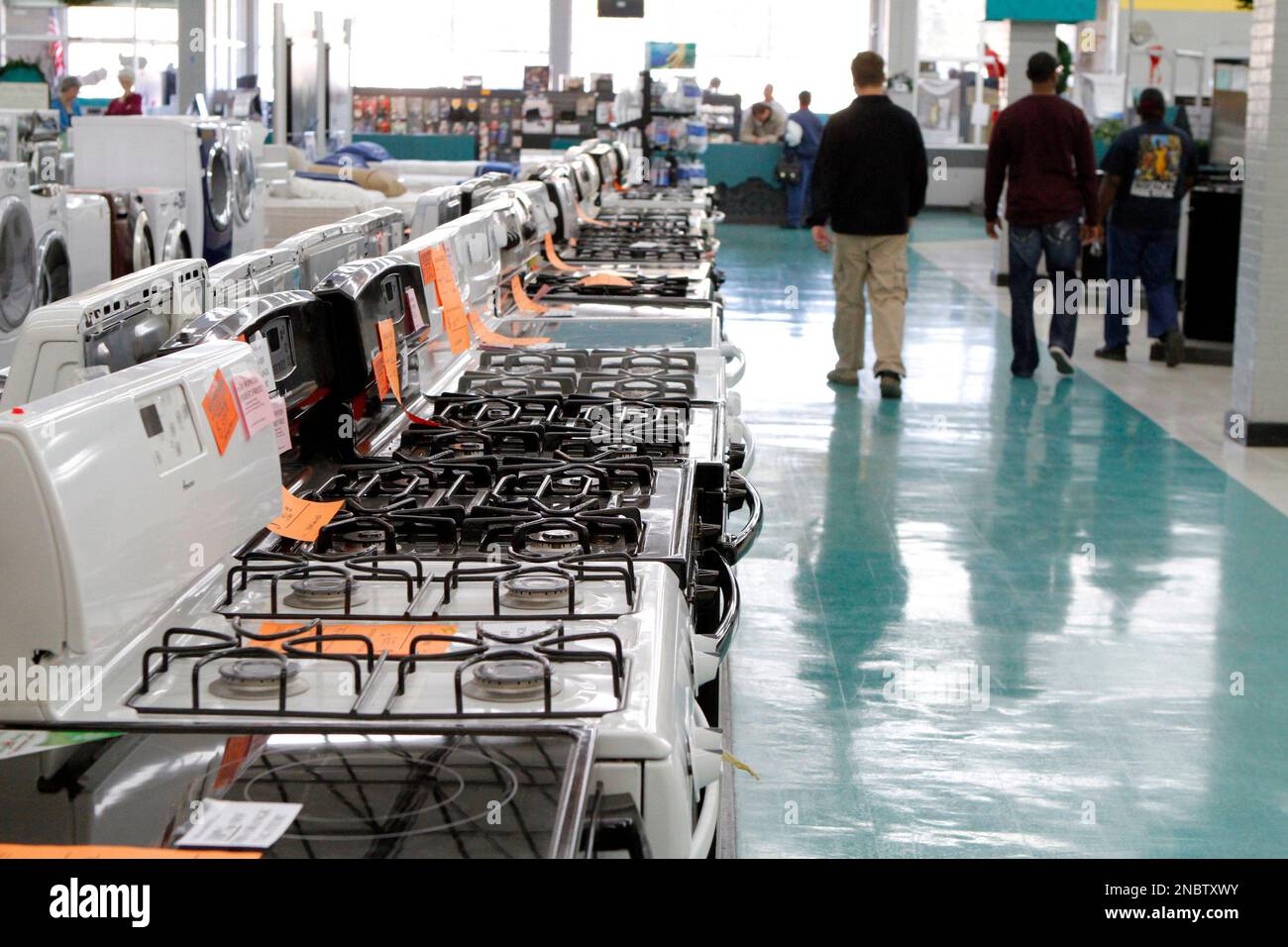 In this Dec. 24, 2010 photograph customers walk past a row of electric