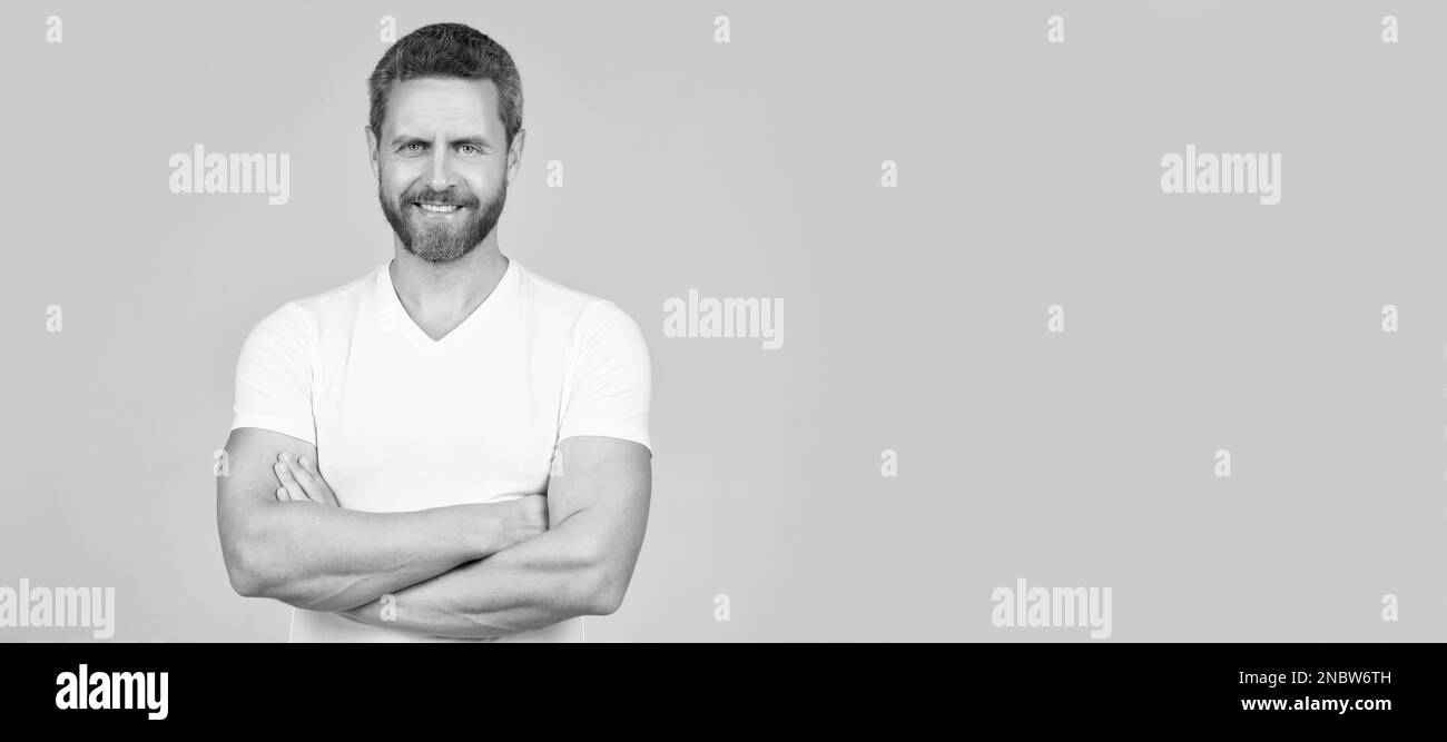 Happy confident man smile keeping arms crossed in white tshirt grey
