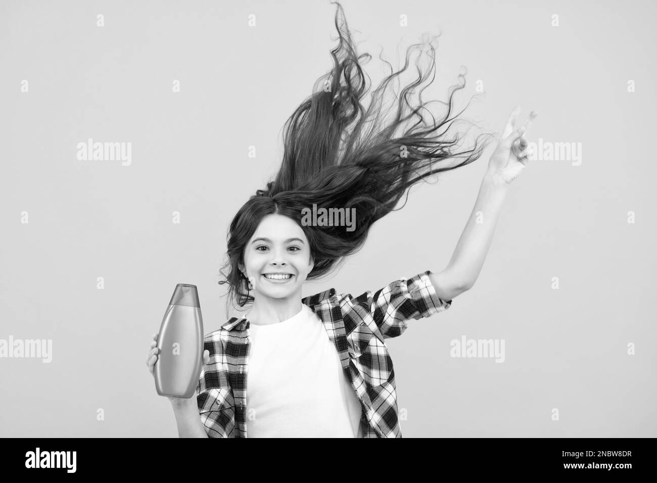 Child teen girl with shampoos conditioners and shower gel. Long hair