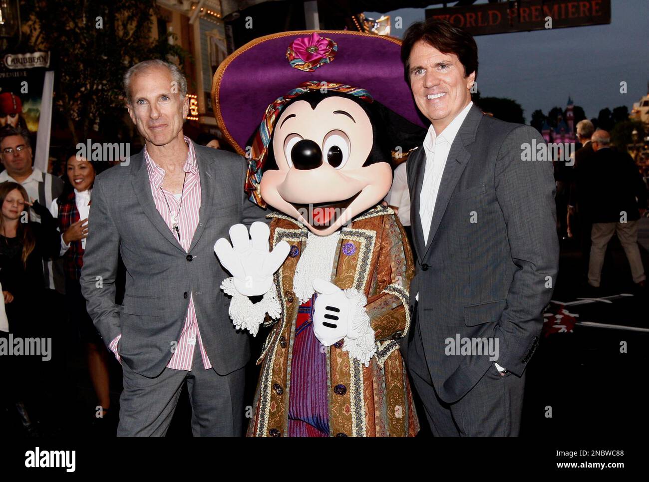 John Deluca, left, Mickey Mouse, and Rob Marshall are seen at the World Premiere of "Pirates of the Caribbean: On Stranger Tides" at Disneyland in Anaheim, Calif., on Saturday, May 7, 2011. (AP Photo/Matt Sayles) Stock Photo