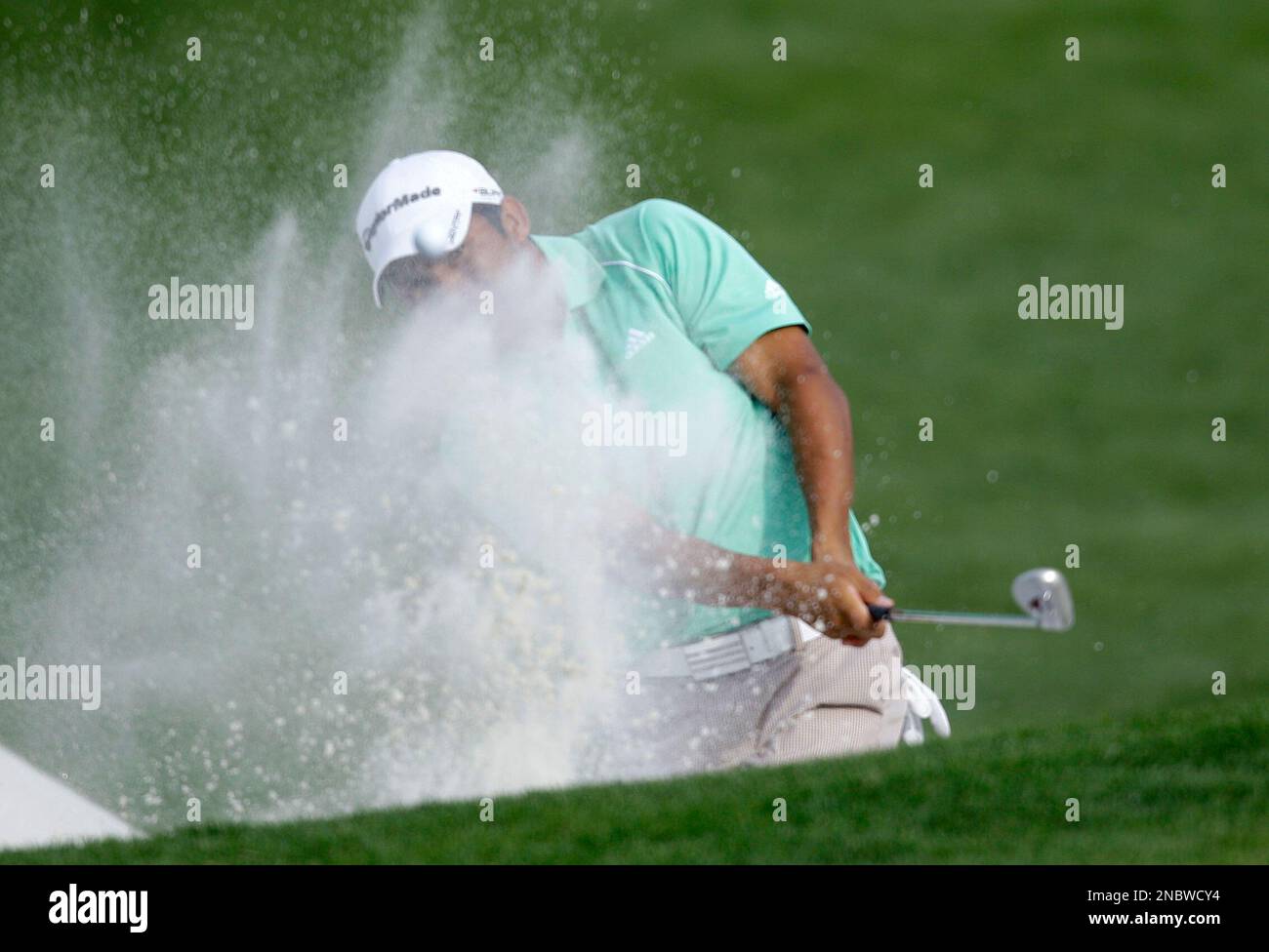 Andres Romero, of Argentina, hits from a sand trap on the 18th hole