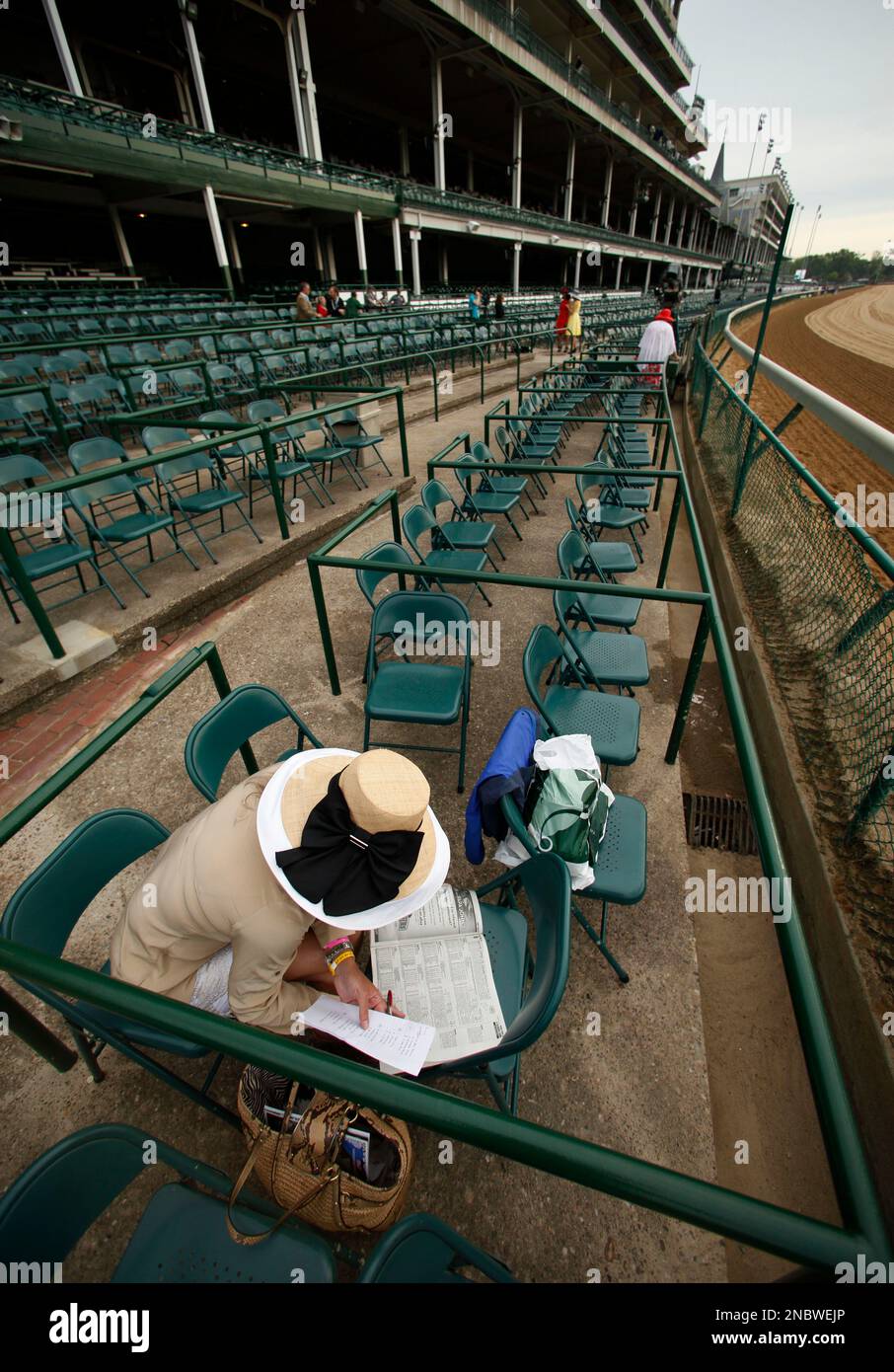 Amanda Lasater, Mason, Tx., checks the racing program ahead of the