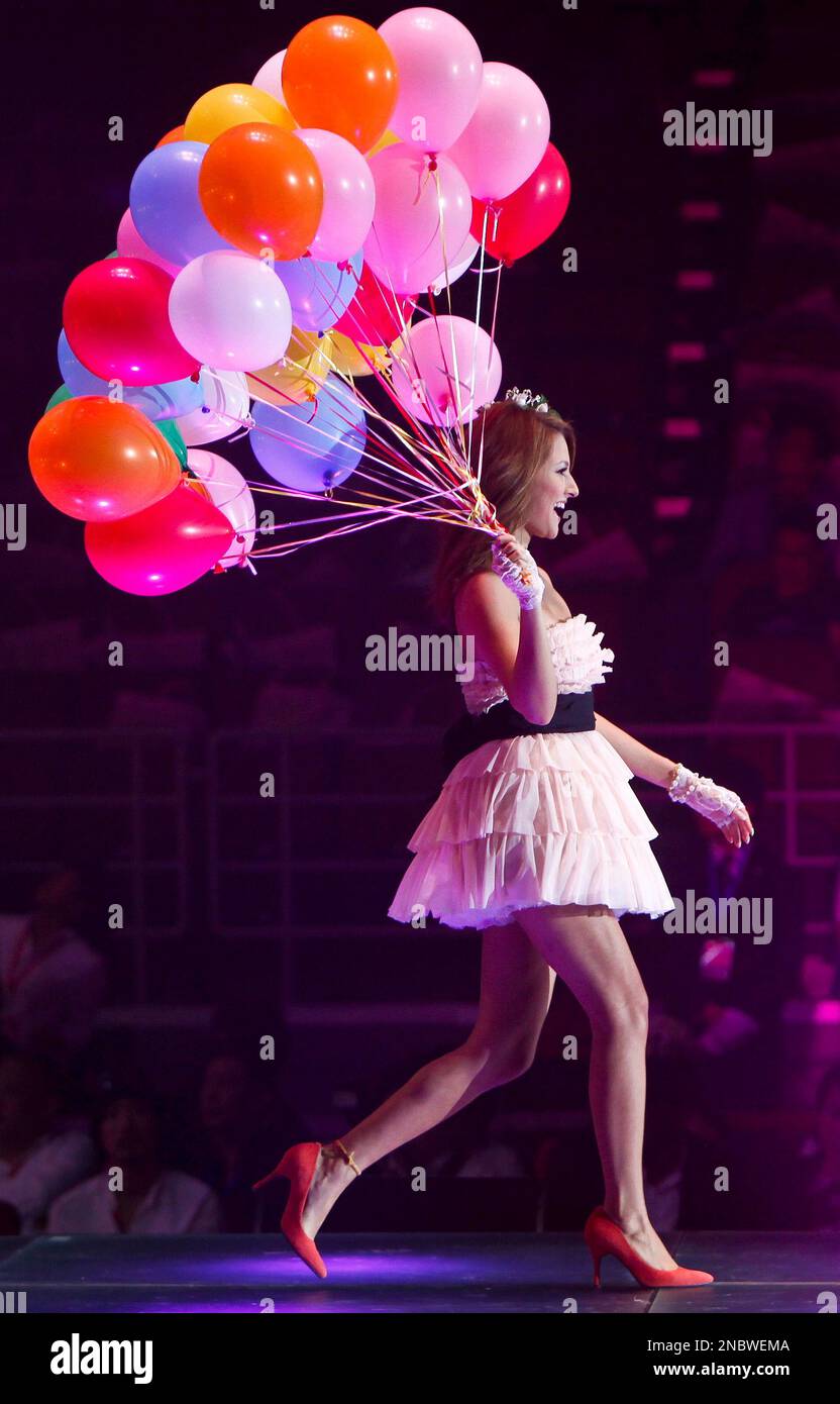 Japanese artist Reika Hashimoto holds balloons while showcasing fashion  produced by Honey's closet during the Tokyo Girls Collection fashion show  held in Beijing Saturday, May 7, 2011. The Tokyo-originated fashion  festival where