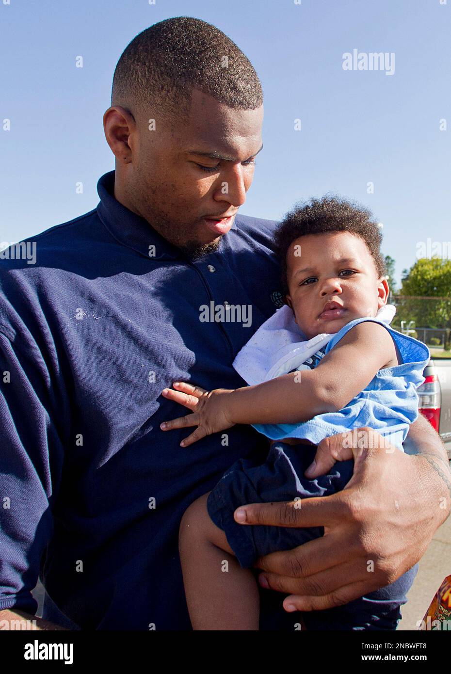 NBA player DeMarcus Cousins holds Jordan Whitfield at the Belk Center