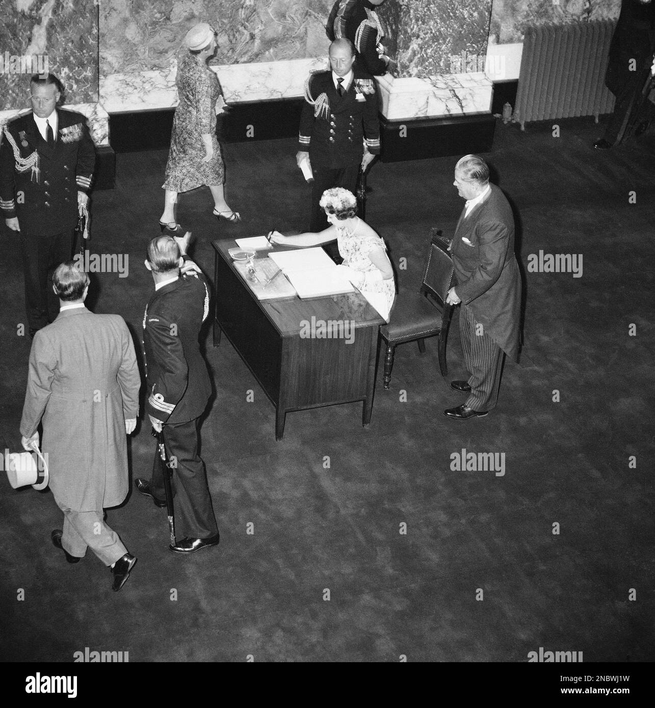 Princess Margaret reaches for pen to sign official guest book in British  Columbia Parliament Bldg. Legislative Chamber during her tour of Victoria,  Canada on July 14, 1958. At right, holding her chair