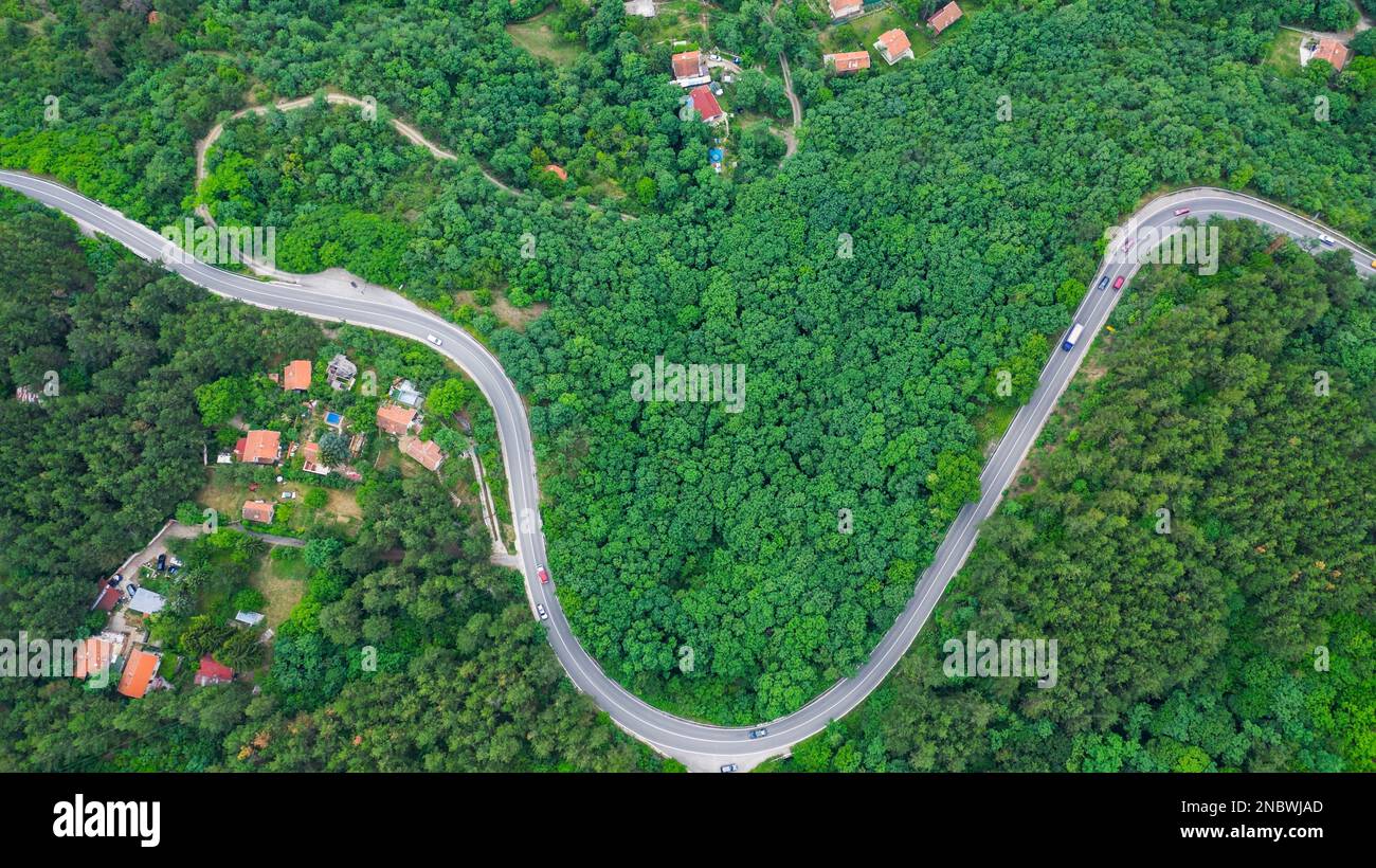 Aerial view of winding road trough the dense woods on the high mountain in Bulgaria. Stock Photo
