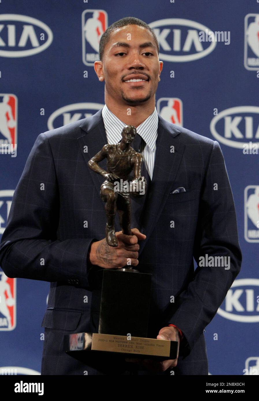 Chicago Bulls Derrick Rose holds the Maurice Podoloff Trophy