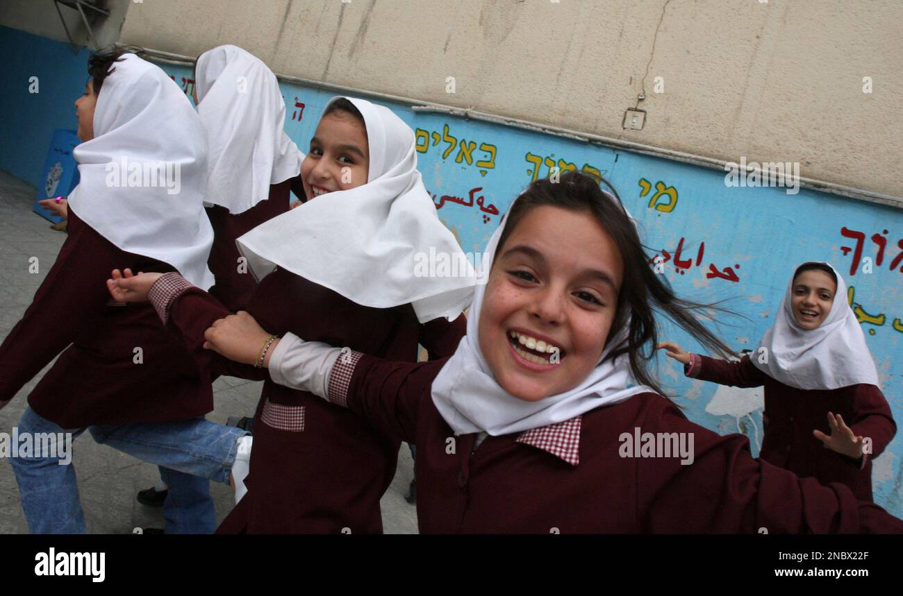 Wearing their Islamic style uniforms, Iranian Jewish school girls, react  with joy, at the Fakhr-e-Danesh school of Iranian Jewish community, in  Tehran, Iran, Tuesday, May 3, 2011. About 20,000 Jews live in