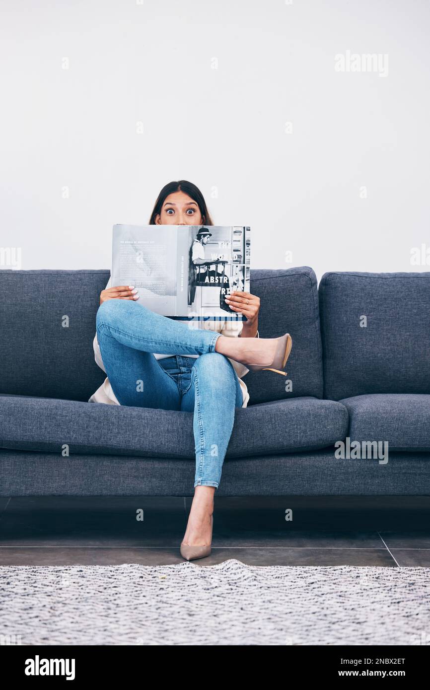 Wow, magazine or woman reading newspaper articles for trendy information on house sofa with wall mockup. Story, surprised or shocked person studying Stock Photo
