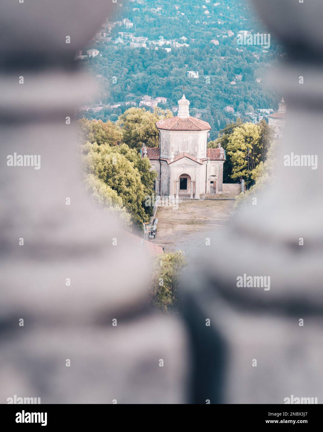 a-vertical-shot-of-sacro-monte-di-varese-chapel-seen-through-a-railing-on-a-sunny-day-in-italy-2NBX3J7.jpg