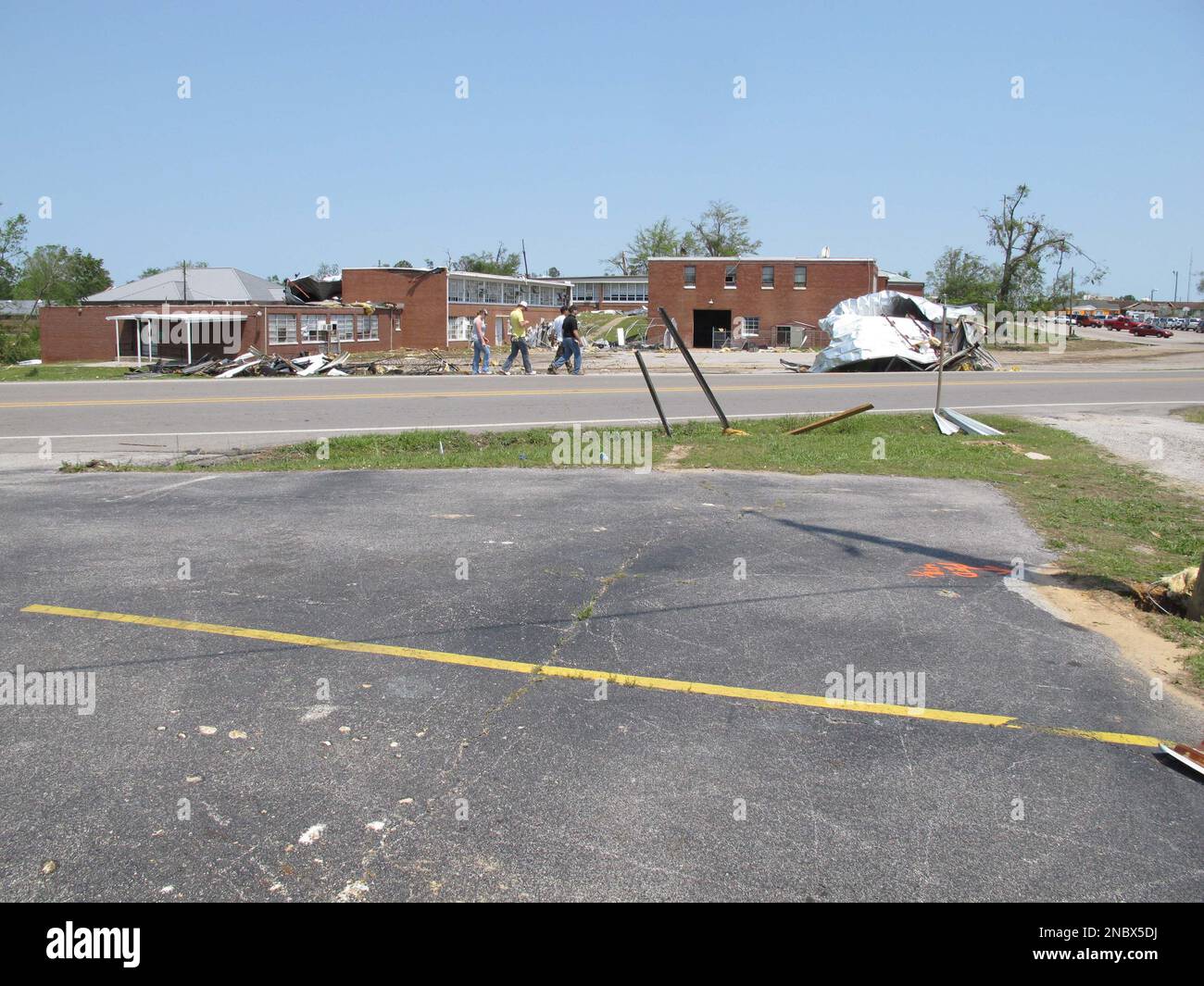 In a April 30, 2011 photo, pedestrians walk past Phil Campbell High