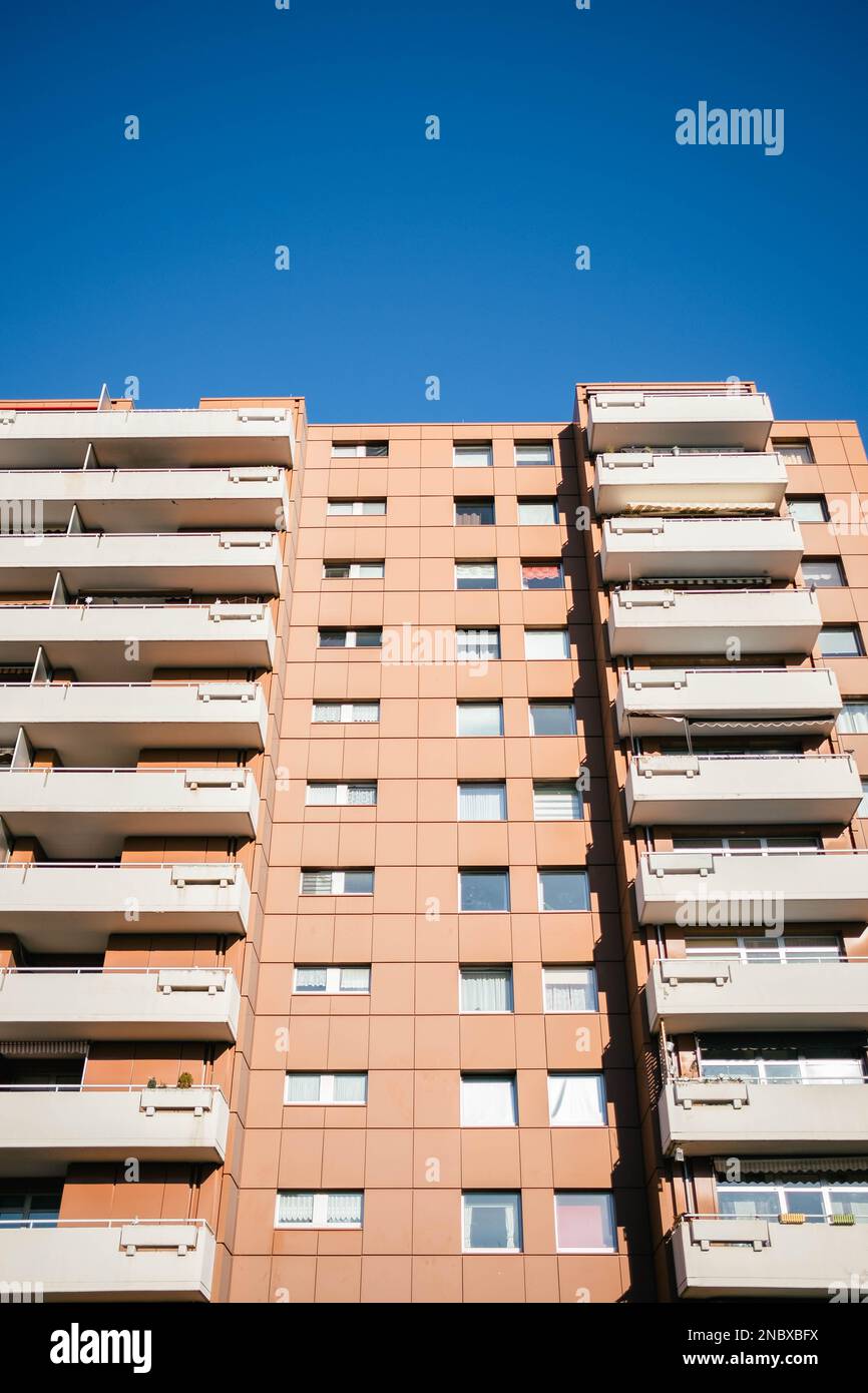 A prefabricated house in the ghetto under a blue sky. The high-rise ...