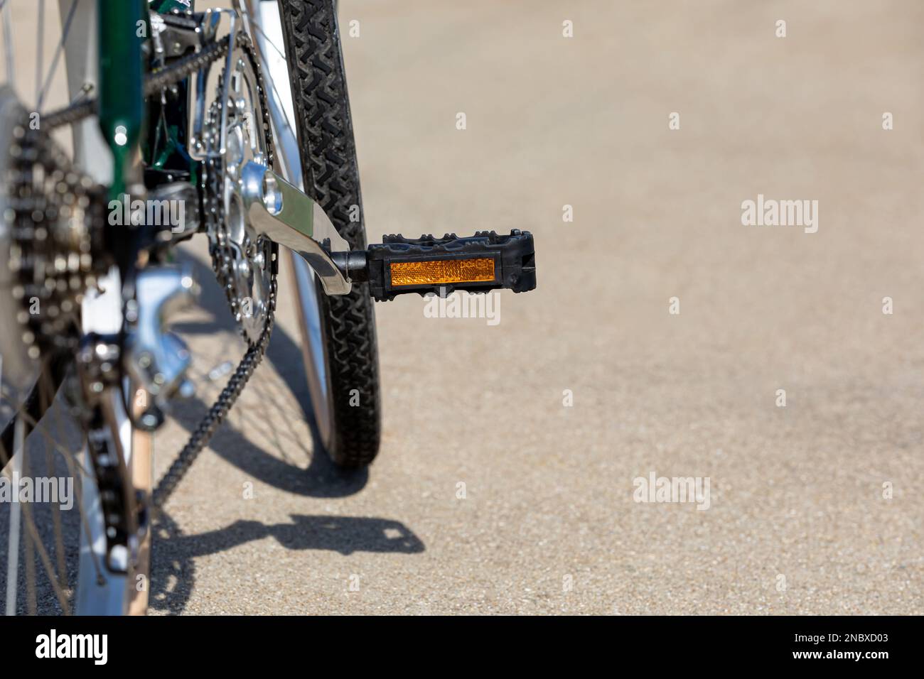 Bicycle with reflector pedal on road during summer. Cycling, biking, and outdoor exercise concept. Stock Photo