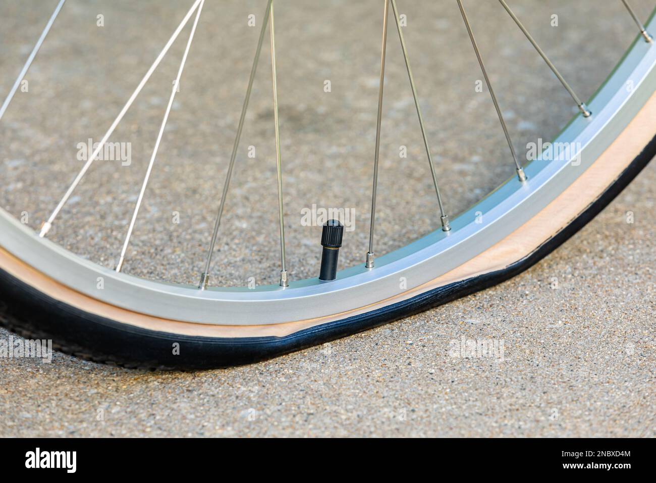 Flat tire on bicycle. Bike maintenance, repair and cycling concept. Stock Photo
