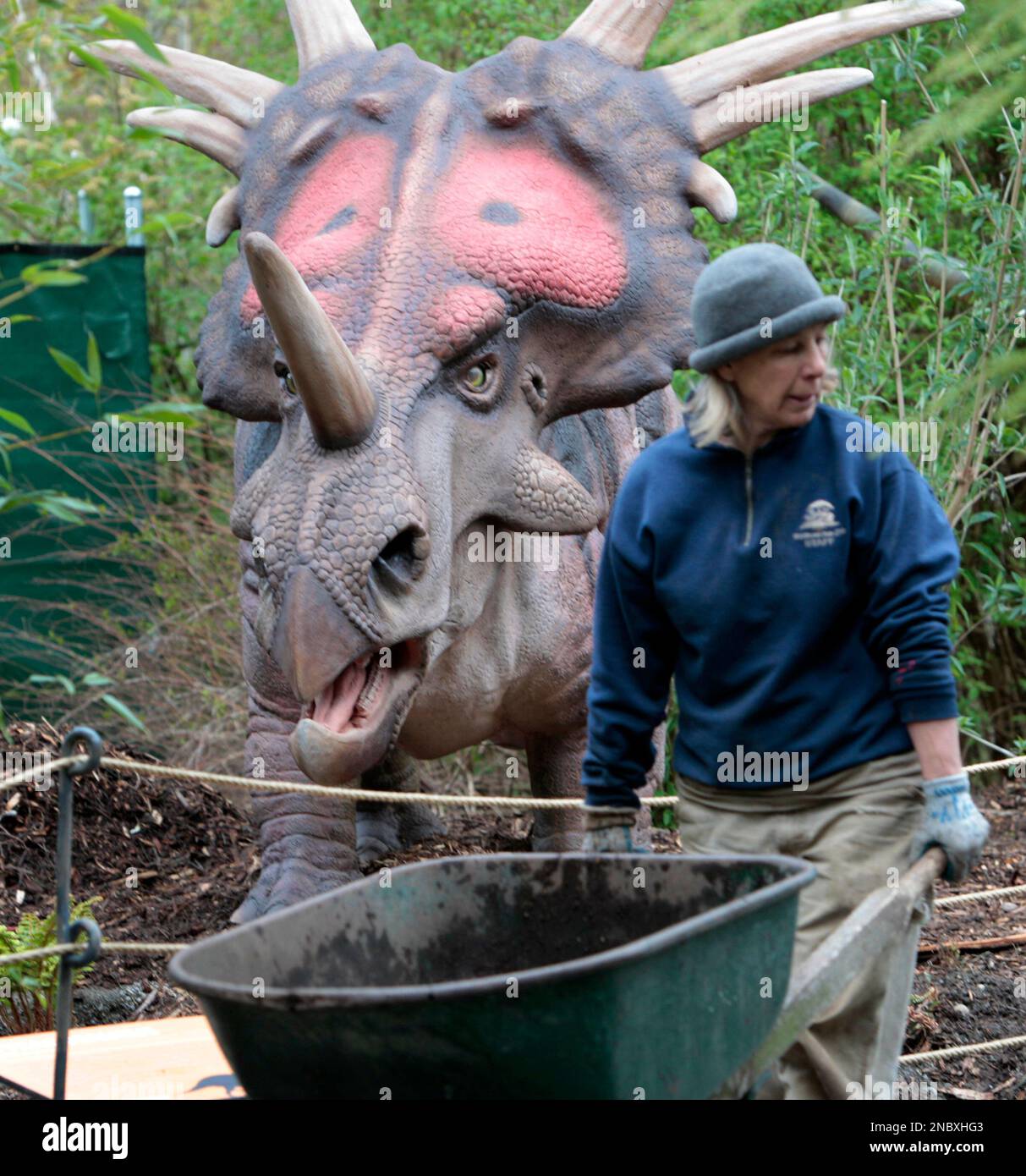 Groundskeeper Robin McCain pushes a wheelbarrow past an animatronic
