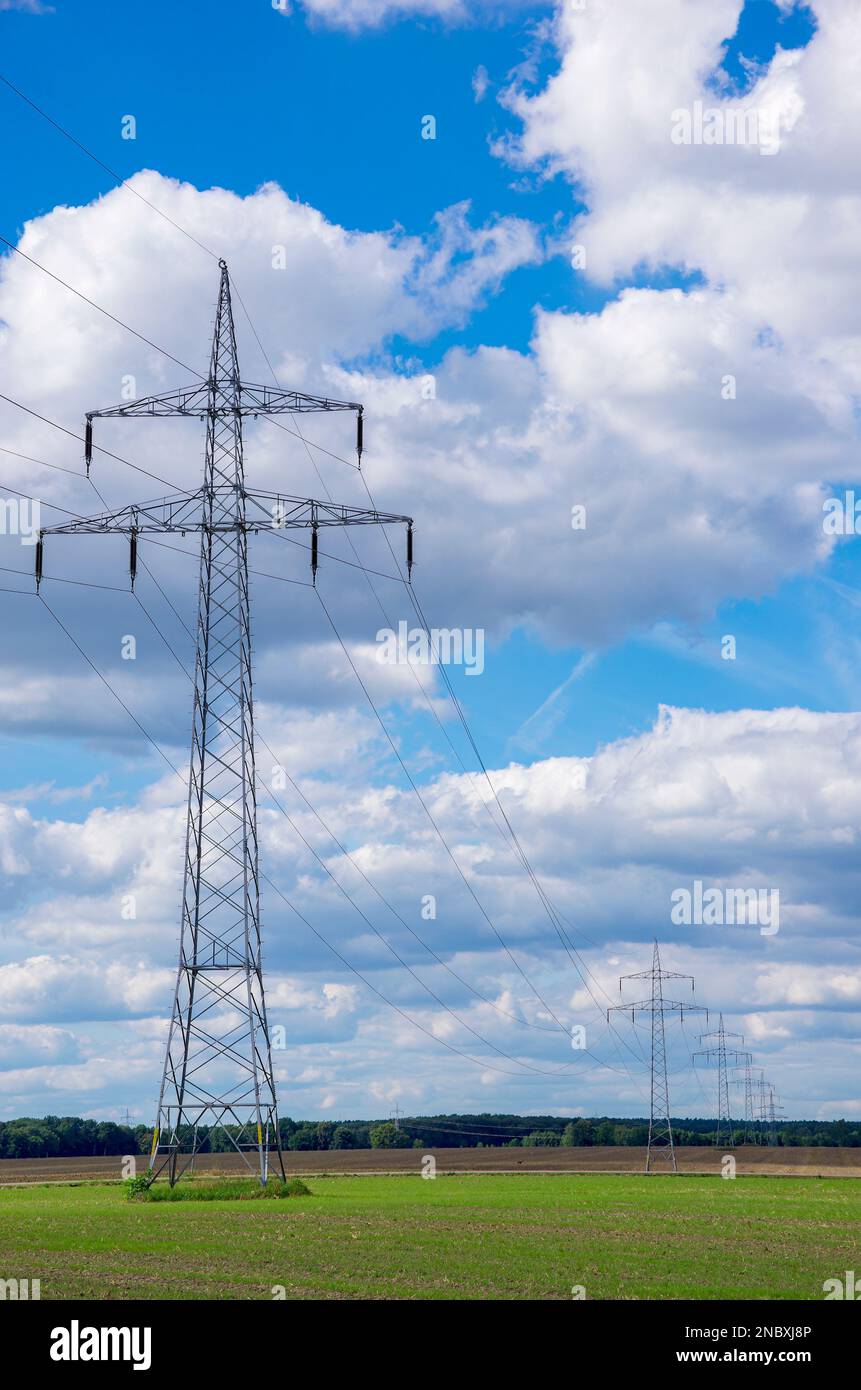 Distribution of electrical energy by means of overland power lines consisting of transmission towers and overhead lines. Stock Photo