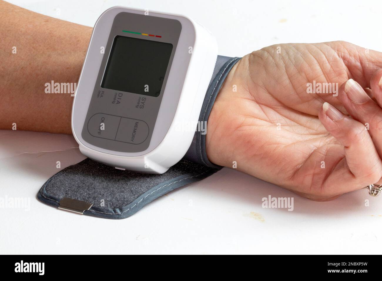 Blood pressure measurement on the wrist of an elderly woman Stock Photo