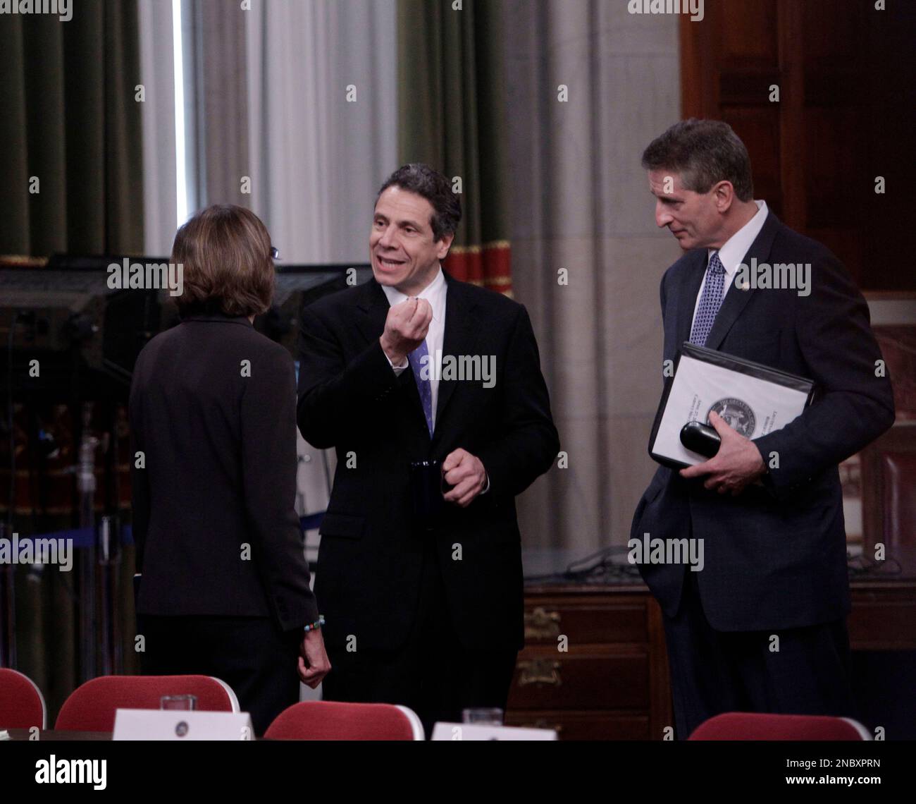 New York Gov. Andrew Cuomo, center, talks with Rose Harvey