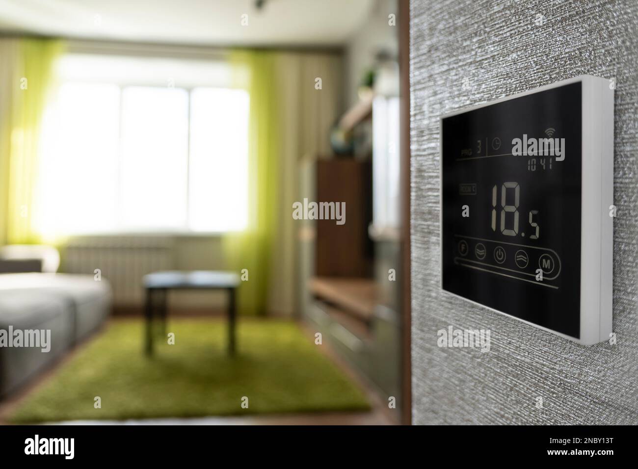 Programmable thermostat for temperature control in home. low temperature in the apartment in winter. 10 degrees Celsius room temperature. electronic t Stock Photo