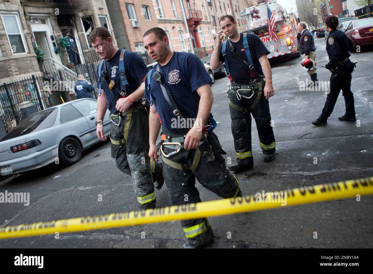Members of the FDNY walk away from the scene of a house fire that ...