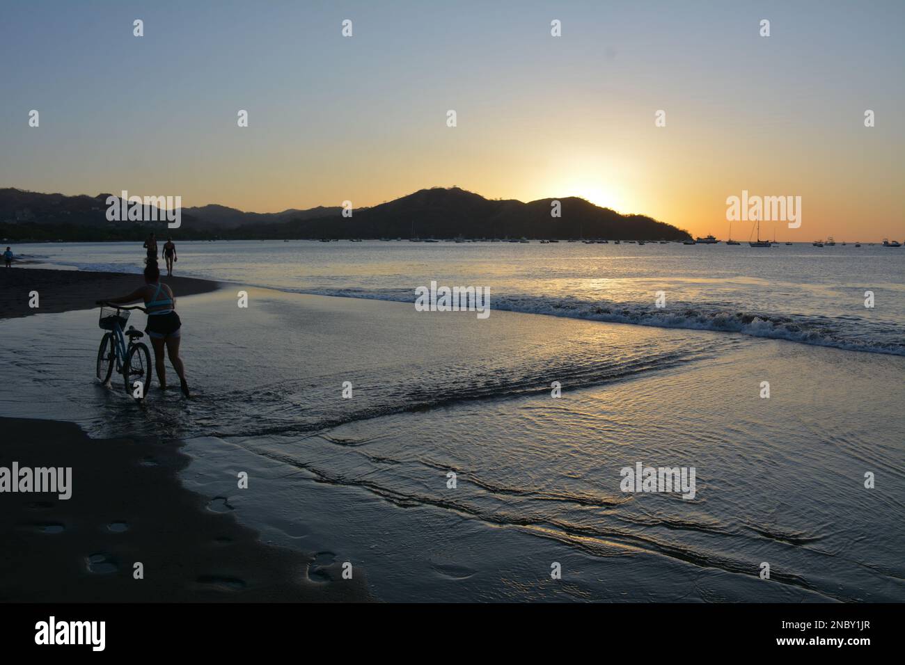 People on beach at sundown on Playa Coco in Costa Rica Stock Photo